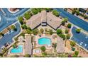 Resort-style community pool and amenity center with manicured landscaping, ample parking, and easy street access at 10608 Kennedy Peak Ln, Las Vegas, NV 89166