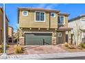 Inviting two-story home with a brick driveway and desert landscaping at 10778 Hickam Ave, Las Vegas, NV 89129