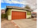 Exterior view of house with an orange garage door at 1080 Laguna Park Ct, Las Vegas, NV 89110