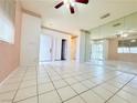 Spacious living room with tile flooring, ceiling fan, and decorative wall trim at 1080 Laguna Park Ct, Las Vegas, NV 89110