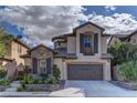 Charming two-story home with a stone-accented facade and a well-maintained front yard under cloudy skies at 11221 Stanwick Ave, Las Vegas, NV 89138