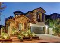 Charming two-story home with a stone-accented facade and a well-maintained front yard at twilight at 11221 Stanwick Ave, Las Vegas, NV 89138