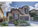 Charming two-story home with a stone-accented facade and a well-maintained front yard under sunny skies at 11221 Stanwick Ave, Las Vegas, NV 89138