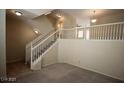 Inviting living room featuring carpet flooring, staircase with white railing, and neutral wall paint at 1505 Couples St, Las Vegas, NV 89128