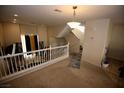Bright loft space featuring carpet flooring, staircase, railing and natural light streaming through the windows at 1505 Couples St, Las Vegas, NV 89128