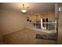 Bright loft space with neutral carpet flooring, open railing, and a view of the lower level at 1505 Couples St, Las Vegas, NV 89128