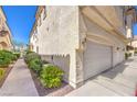 Side exterior elevation features sidewalk, desert landscaping, and multi-car garage at 1634 Clint Canyon Dr, Henderson, NV 89002
