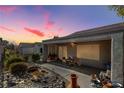 Backyard patio with rock landscaping, covered sitting area, and stylish garden decor at 2142 Oliver Springs St, Henderson, NV 89052