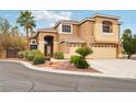 Stucco home with a three-car garage, front lawn, and desert landscaping at 2337 Ivory Point Ct, Las Vegas, NV 89134