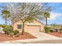 Charming single-story home featuring a well-maintained yard, two-car garage, and mature trees at 2810 Lava Rock Ave, North Las Vegas, NV 89031
