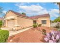 Single-story home featuring a well-maintained yard, with desert landscaping for low maintenance at 2810 Lava Rock Ave, North Las Vegas, NV 89031
