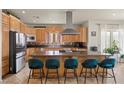 Spacious kitchen with ample counter space, wooden cabinetry, and an eat-in island at 319 Belfast St, Henderson, NV 89015
