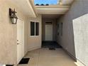 Inviting front entry featuring a covered porch area, with direct access to an additional side entry door at 3213 Partridge Run St, Laughlin, NV 89029