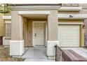 Close-up of a home's entrance, highlighting the front door, trim and single car garage at 3650 Mcmurty Ct, Las Vegas, NV 89129