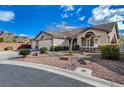 Beautifully landscaped front yard with desert plants and stone accents creating a welcoming entry at 3734 John Bailey St, Las Vegas, NV 89129