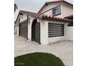 View of the home's front exterior featuring an attached garage and an arched entry gate at 4054 Venita Ct, Las Vegas, NV 89120