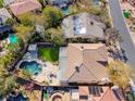 Aerial view of a home with a pool, spa, artificial grass and a pergola-covered patio at 4481 Grey Spencer Dr, Las Vegas, NV 89141