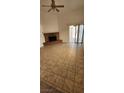 Bright living room features brick fireplace, tile floors, and sliding glass doors at 503 Crony Ave, Henderson, NV 89011