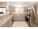 Beautiful kitchen with gray cabinets, stainless steel appliances, and granite countertops at 5250 S Rainbow Blvd # 2033, Las Vegas, NV 89118