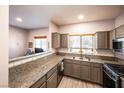 Well-lit kitchen featuring granite countertops, stainless steel appliances, and neutral cabinets at 5250 S Rainbow Blvd # 2033, Las Vegas, NV 89118