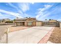 This home features a spacious driveway leading up to a charming two-story home with desert landscaping at 5751 E Owens Ave, Las Vegas, NV 89110