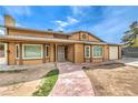 Inviting two-story house featuring a walkway to the front door and an attached garage at 5751 E Owens Ave, Las Vegas, NV 89110