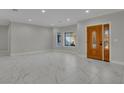 Spacious living room features marble floors and a detailed wooden front door at 60 E Levi Ave, Las Vegas, NV 89183