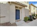 Charming townhouse entrance with a classic blue front door and manicured landscaping at 6255 W Arby Ave # 193, Las Vegas, NV 89118