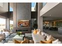 Bright living room with modern fireplace, comfortable seating, and floor to ceiling windows with outside views at 709 Dragon Peak Dr, Henderson, NV 89012