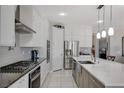 Stylish kitchen with white cabinets, stainless steel appliances, and a modern island with pendant lighting at 8286 Skye Gorge St, Las Vegas, NV 89166