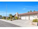 View of the home's driveway, landscaping, and exterior features at 8620 Cremona Dr, Las Vegas, NV 89117