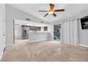 Spacious living room with tile floors, ceiling fan, and view of the kitchen at 8620 Cremona Dr, Las Vegas, NV 89117