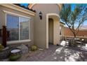 Charming front entrance features a decorative turret, desert landscaping, and a cozy patio area at 950 Overland Trl, Mesquite, NV 89034
