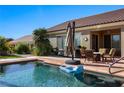 Backyard pool with patio seating, outdoor kitchen, and desert landscaping provides a relaxing outdoor living space at 950 Overland Trl, Mesquite, NV 89034