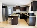 Charming kitchen featuring stainless steel appliances, granite countertops, and a center island at 9746 Brooks Lake Ave, Las Vegas, NV 89148