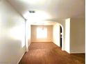 Bright living room with arched doorway and neutral decor, ready for personal touches at 9746 Brooks Lake Ave, Las Vegas, NV 89148