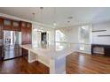 Beautiful kitchen with granite countertop island, stainless steel appliances, and wood floors at 1009 Ancient Timber Ave, Henderson, NV 89052