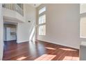 Spacious living room with hardwood floors, tall ceilings, and abundant natural light at 10216 Via Roma Pl, Las Vegas, NV 89144