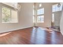 Bright living room featuring high ceilings, hardwood floors, and ample windows at 10216 Via Roma Pl, Las Vegas, NV 89144