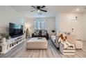Bright living room featuring neutral tones, modern furnishings, and a ceiling fan at 1328 Graphite Ave, Henderson, NV 89002