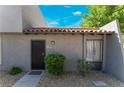 Front exterior showing a well-maintained yard, an inviting entrance, and attractive gray stucco siding at 1340 N Jones Blvd, Las Vegas, NV 89108