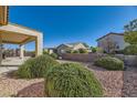 Backyard with desert landscaping and covered patio at 2088 Sawtooth Mountain Dr, Henderson, NV 89044