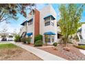 Exterior corner view with blue awnings over the windows at 2673 Red Rock St # 102, Las Vegas, NV 89146