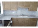 Kitchen featuring a dual basin sink, tile backsplash, and plenty of cabinet storage at 3946 Voxna St, Las Vegas, NV 89119