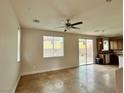 Inviting living room with tile floors, natural light, and sliding glass door at 4520 Lemon Gems Ct, Las Vegas, NV 89130