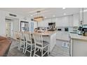 Bright, remodeled kitchen with white cabinets, stainless steel appliances, and spacious center island with seating at 4937 Elaina Ave, Las Vegas, NV 89120