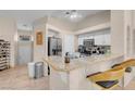 Bright kitchen with granite countertops and bar seating, open to the dining and living areas at 5000 Red Rock St # 241, Las Vegas, NV 89118