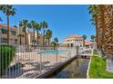 Inviting community pool surrounded by lush palm trees and well-maintained landscaping, perfect for relaxation at 5000 Red Rock St # 241, Las Vegas, NV 89118