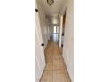 Hallway with tiled flooring leading to a bright living area with french doors to the backyard at 510 Holick Ave, Henderson, NV 89011