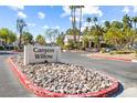 Canyon Willow community sign with mature palm trees and manicured landscaping in a tranquil setting at 5211 Caspian Springs Dr # 201, Las Vegas, NV 89120